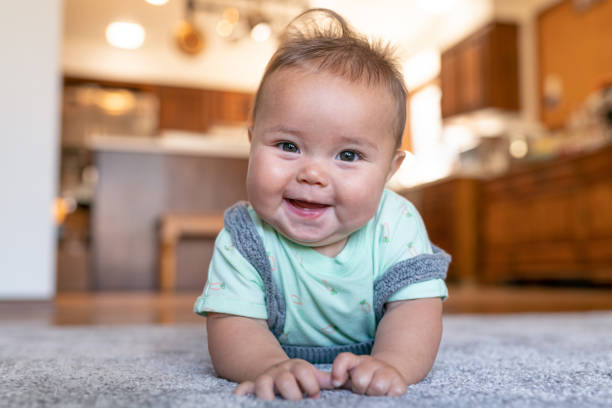 Baby laying on carpet floorings | J/K Carpet Center, Inc